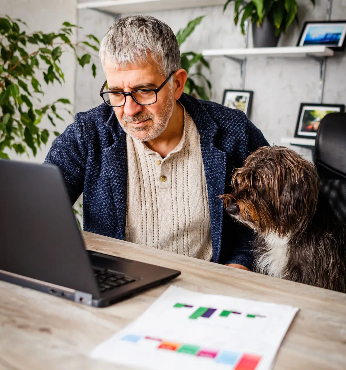 Man working on laptop with dog