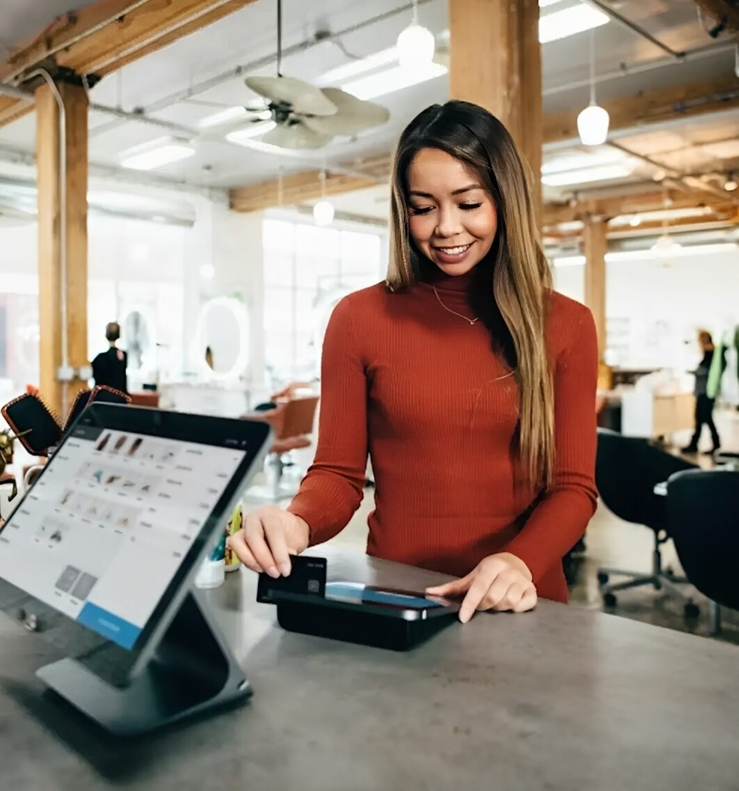 Woman paying at counter with card