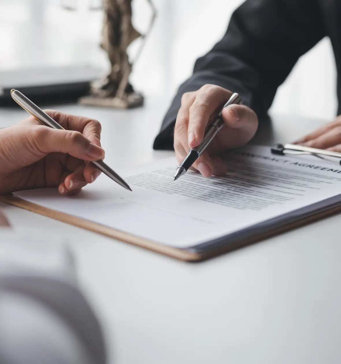 Hands signing contract agreement